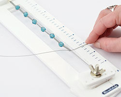 Hands wrapping wire in the tool